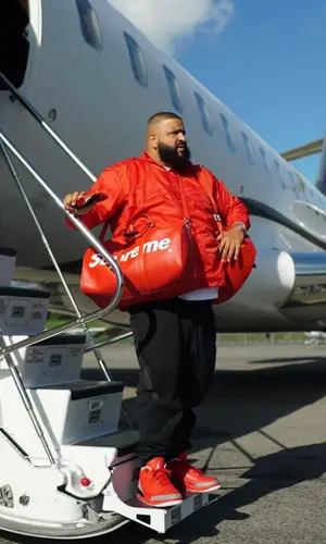 DJ Khaled wearing Supreme bag
