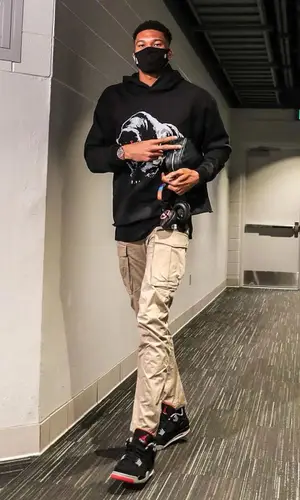 Giannis Antetokounmpo wearing Louis Vuitton bag