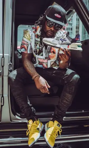 Wale wearing Nike sneakers