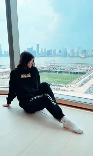 Charli D'Amelio wearing Social Tourist sweatshirt