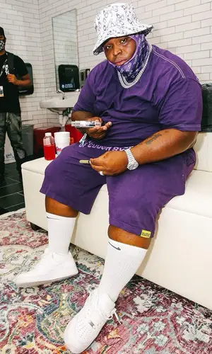 Morray wearing Cough Syrup shorts