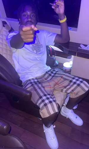 Lil Tjay wearing Burberry shorts