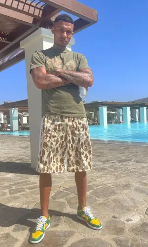 Fredo wearing Nike sneakers