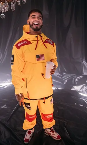 Anuel AA wearing Supreme jacket