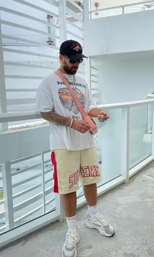 Feid wearing Supreme shorts