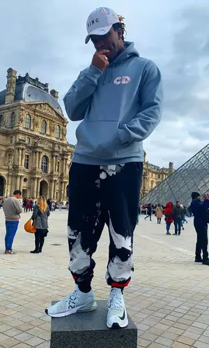 KSI wearing King cap