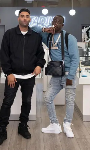 Bobby Shmurda wearing Louis Vuitton bag