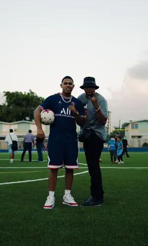 Myke Towers wearing Nike jersey