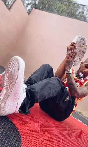 DDG wearing Atlanta Hawks jersey