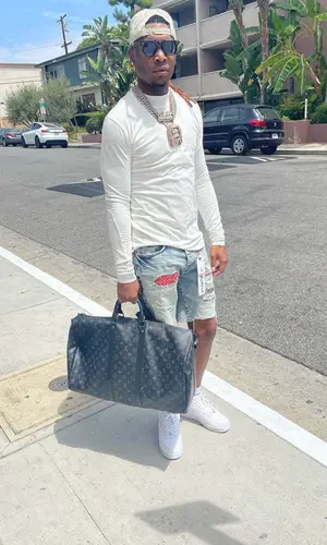 Lil Keed wearing Purple Brand shorts