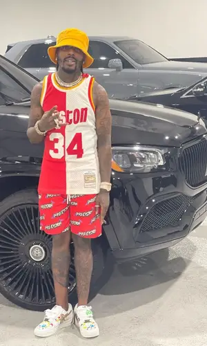 Sauce Walka wearing Mitchell & Ness jersey