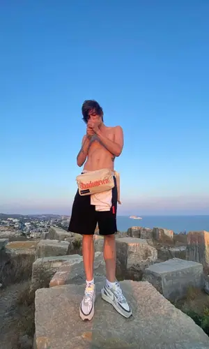 OG Buda wearing Puma bag