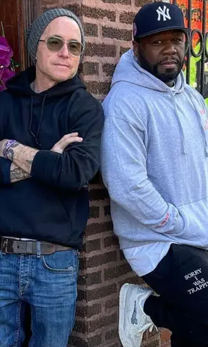 50 Cent’s Outfit in Sorry I Was Trapping Hoodie, Louis Vuitton Sneakers & New Era Cap (2021)