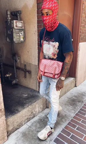 DDG wearing Goyard bag