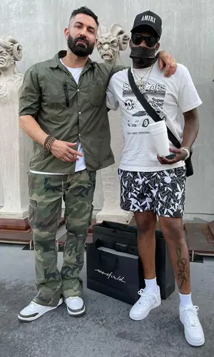 Lil Duke’s Outfit in Catchy Design Studio T-Shirt, Givenchy Eyewear & Amiri Cap (2021)