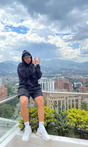 Feid’s Outfit in Feid Merch Hoodie, Supreme Cap & Nike (2021)