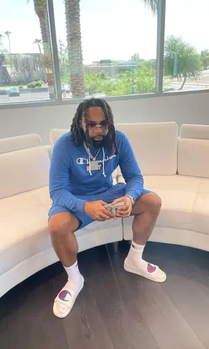 Money Man wearing Champion shorts