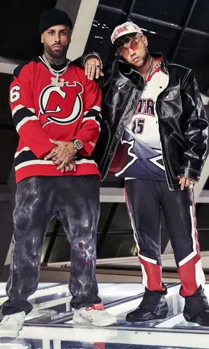 Nicky Jam wearing Alexander McQueen pants