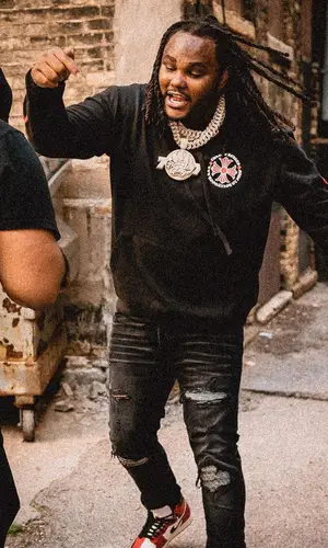 Tee Grizzley wearing Amiri jeans