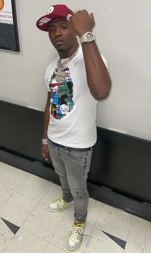 Bankroll Freddie wearing New Era cap
