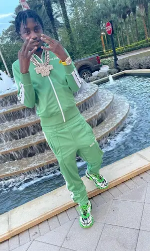 Lil Tjay wearing Palm Angels pants
