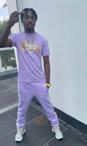 Lil Tjay wearing Palm Angels pants