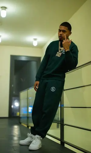 Myke Towers wearing Burberry sweatshirt