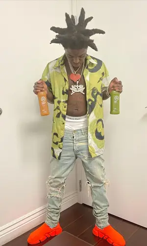 Kodak Black wearing Heron Preston shirt
