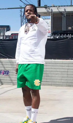 Rowdy Rebel wearing Nike sneakers