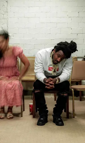 Mozzy wearing Amiri jeans