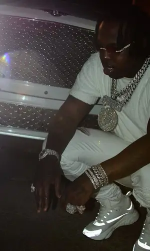 EST Gee wearing Amiri jeans