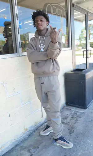 Quando Rondo wearing Fear of God hoody