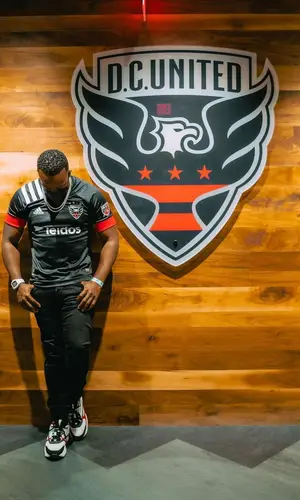 Yo Gotti wearing Adidas jersey