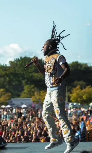 Burna Boy wearing Against Medical Advice sweater