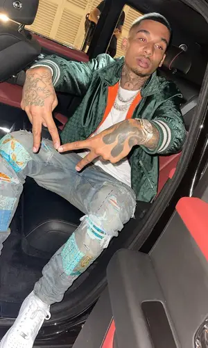 Fredo wearing Nike sneakers