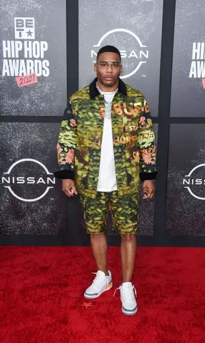 Nelly wearing Burberry jacket