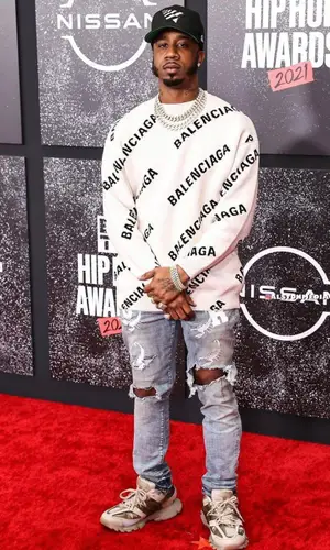 Benny The Butcher wearing Purple Brand jeans