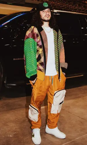 Russ wearing Palm Angels sweater