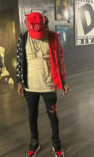 Skooly wearing Culture Vulture Garments jeans