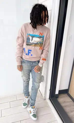 Young M.A’s Outfit in Heron Preston Sweatshirt, Purple Brand Jeans & Nike Sneakers (2021)