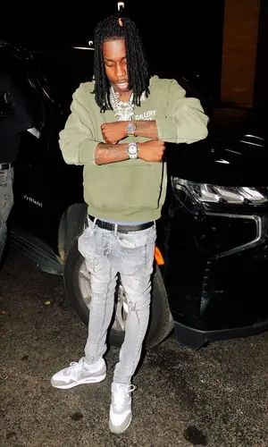 Polo G wearing Louis Vuitton backpack