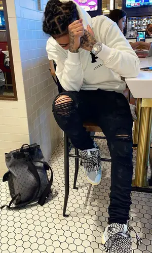 Young M.A wearing Purple Brand hoody