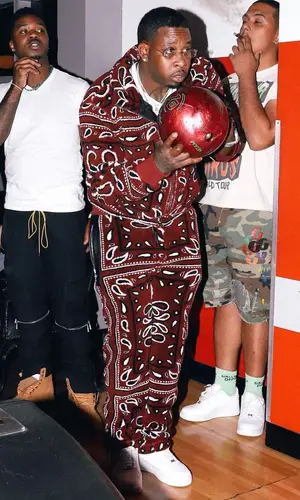 Lil Duke wearing Amiri pants