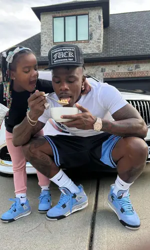 DaBaby wearing Mitchell & Ness shorts