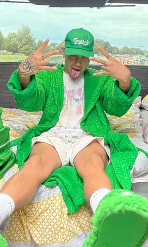 Slowthai wearing Slowthai Merch cap