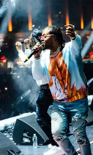 Rowdy Rebel wearing Louis Vuitton belt
