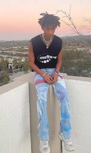 Jaden Smith wearing Jaden Smith Merch sneakers