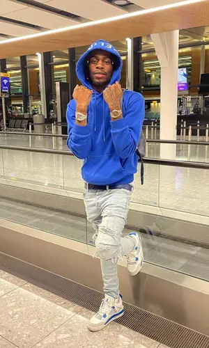 Russ Millions’ Outfit in Celine Hoodie, Jordan Sneakers & Louis Vuitton Backpack (2021)
