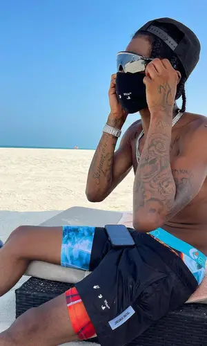 Russ Millions wearing Off-White hat