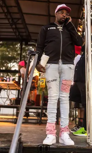 Lil Duke wearing Vicaire jeans
